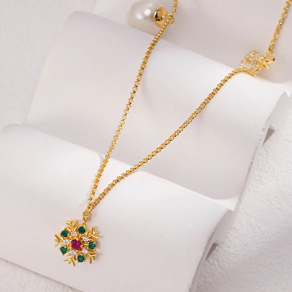 A gold necklace elegantly displayed on a white stand, featuring a sunburst pendant with multicolored gemstones at the center and a large, solitary pearl. The chain is simple, ensuring that the focus remains on the intricate design of the pendant and the pearl, signifying a blend of modern luxury and classic beauty.